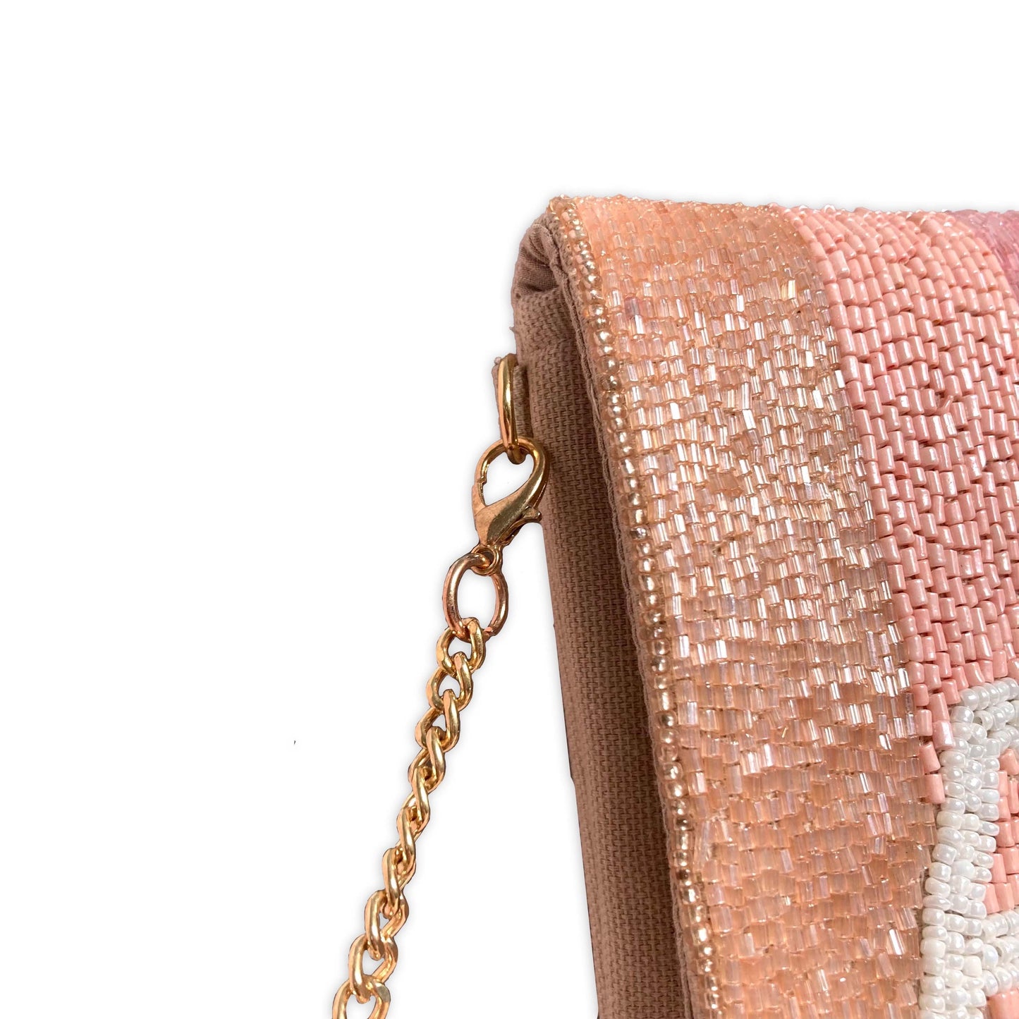 Beaded clutch bag with embellishments which is secured by a gold chain for cross-body wearing