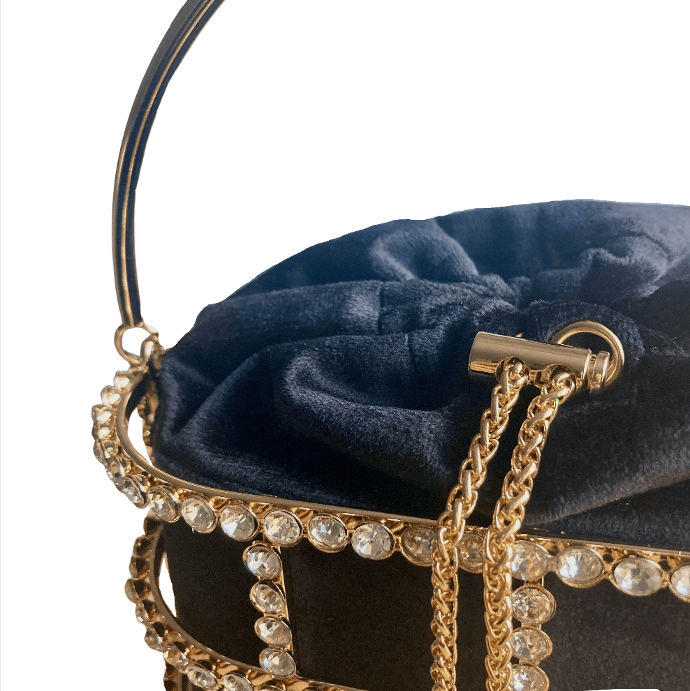 gold metal handle with an embellished cage fully lined with a structured black velvet pouch