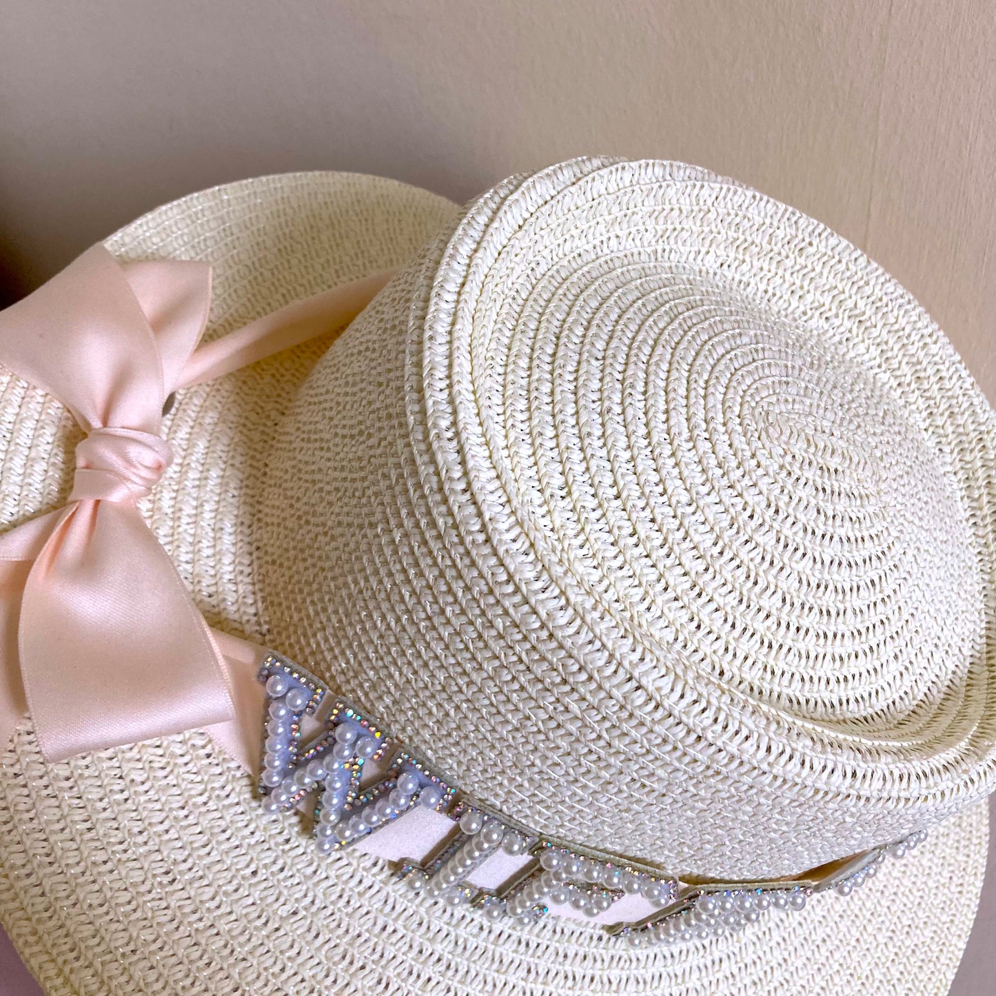 Bridal straw hat for beach goers with pink ribbon decoration