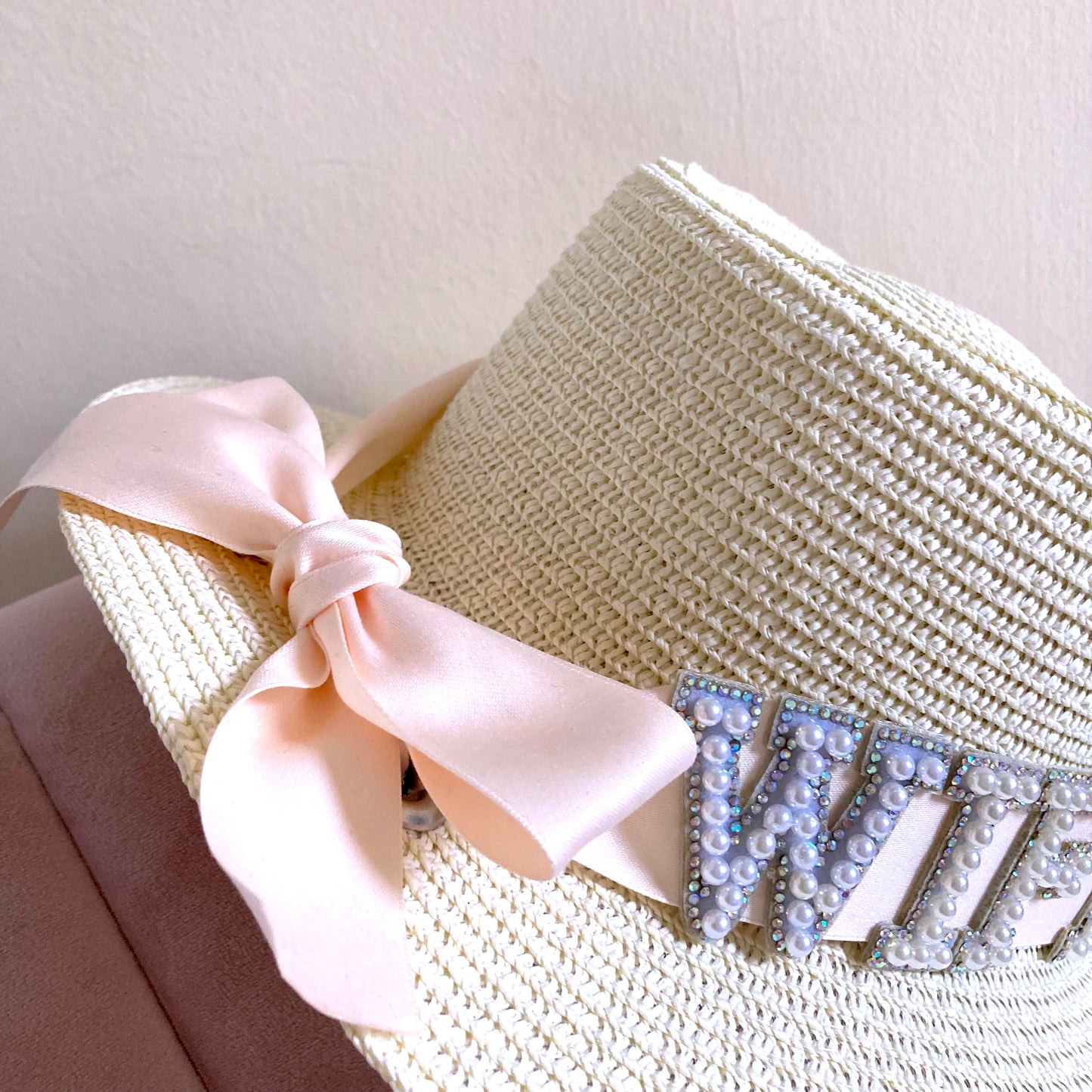 Bridal straw hat with pink ribbon and rhinestone embellishments