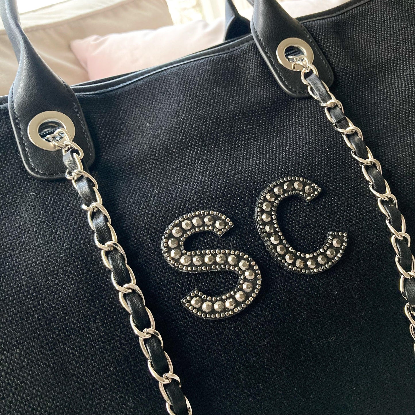 embellished lettering with carry chain on the large black canvas tote