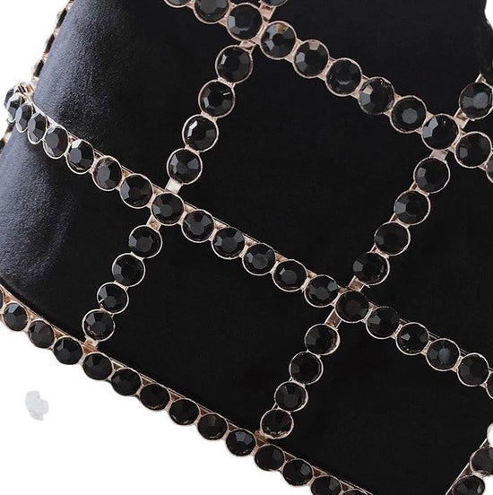 black jewels on the gold cage which supports the bag