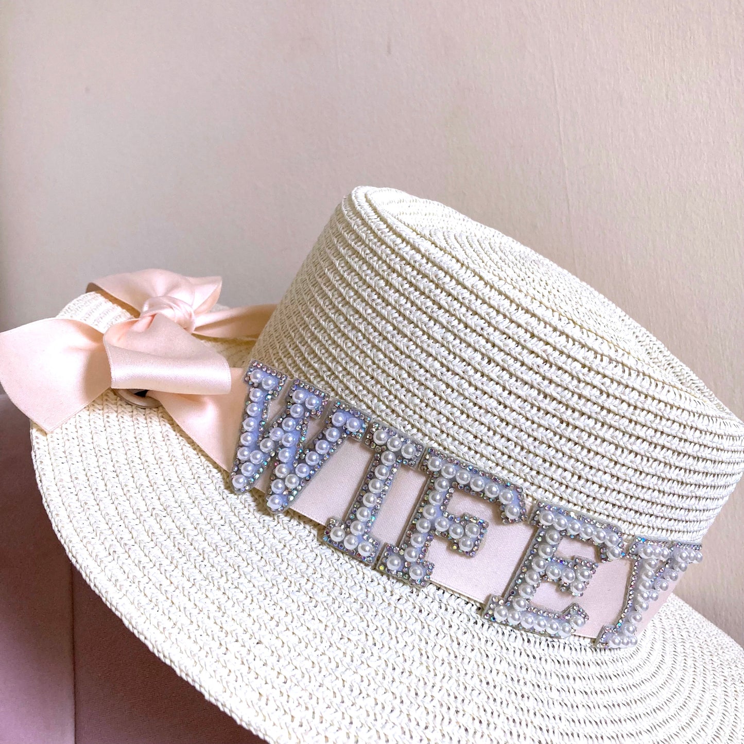 Honeymoon straw beach hat with a light pink ribbon and cyrstal lettering 'wifey'