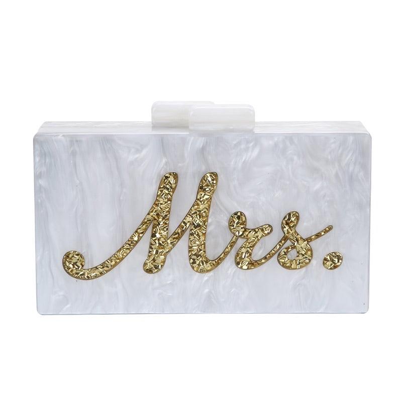 'Mrs.' clutch bag with golden reflective lettering on the front