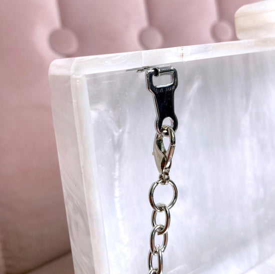 removable silver chain which enables the bag to be carried over the shoulder 