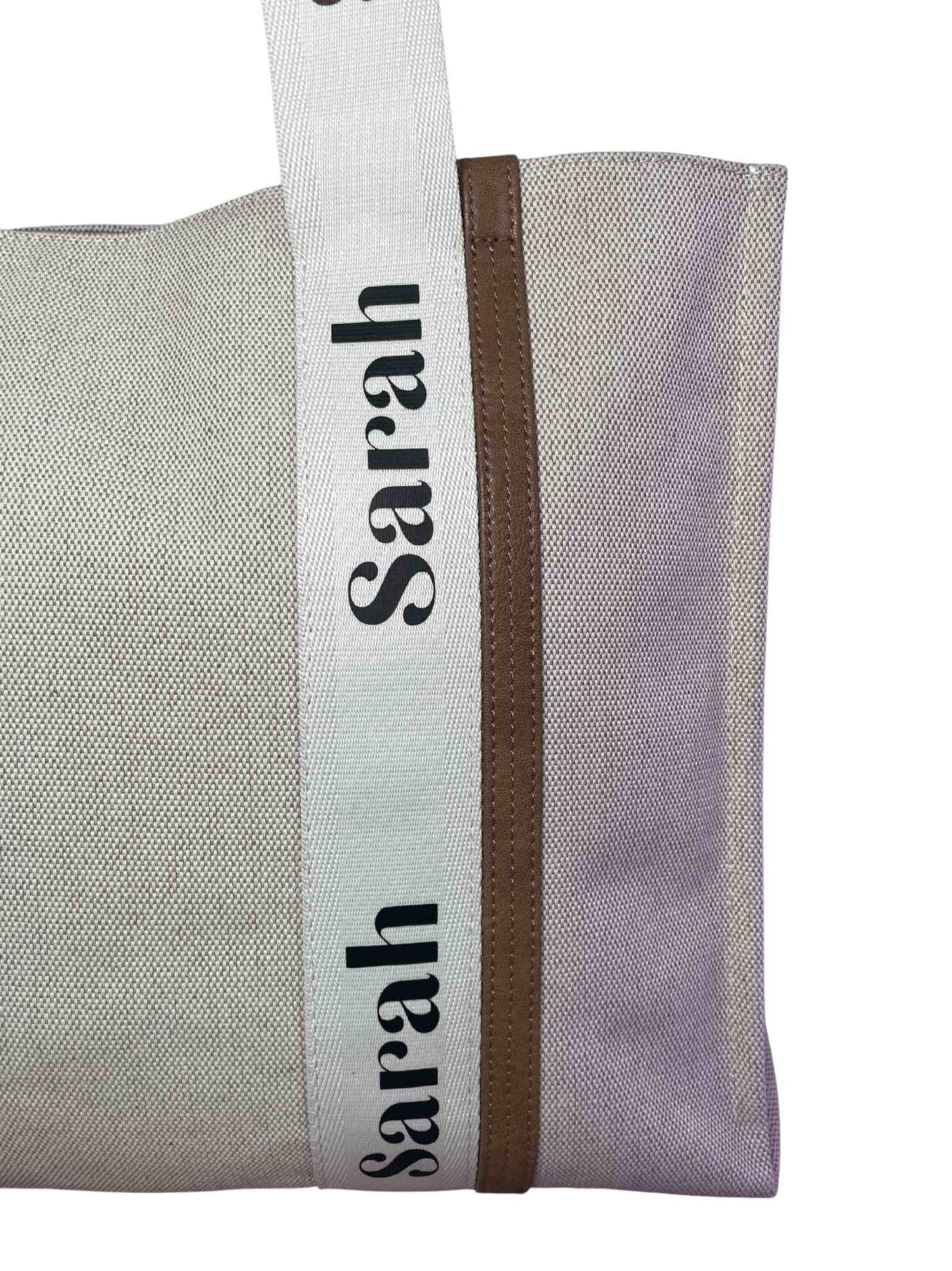 Personalised name imprinted on the ribbon across the main body of the bag