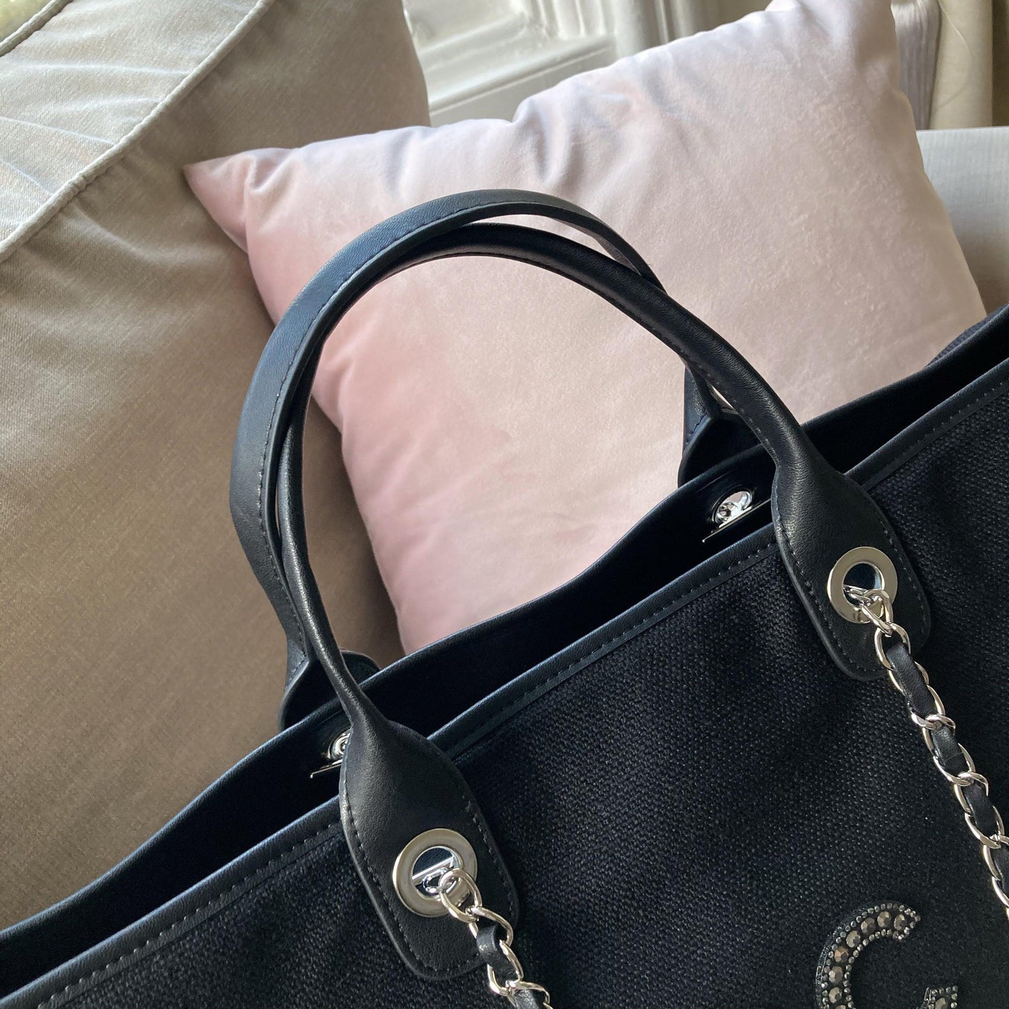 A close-up of the PU leather handles on the overnighter tote which provide a sturdy carrying option