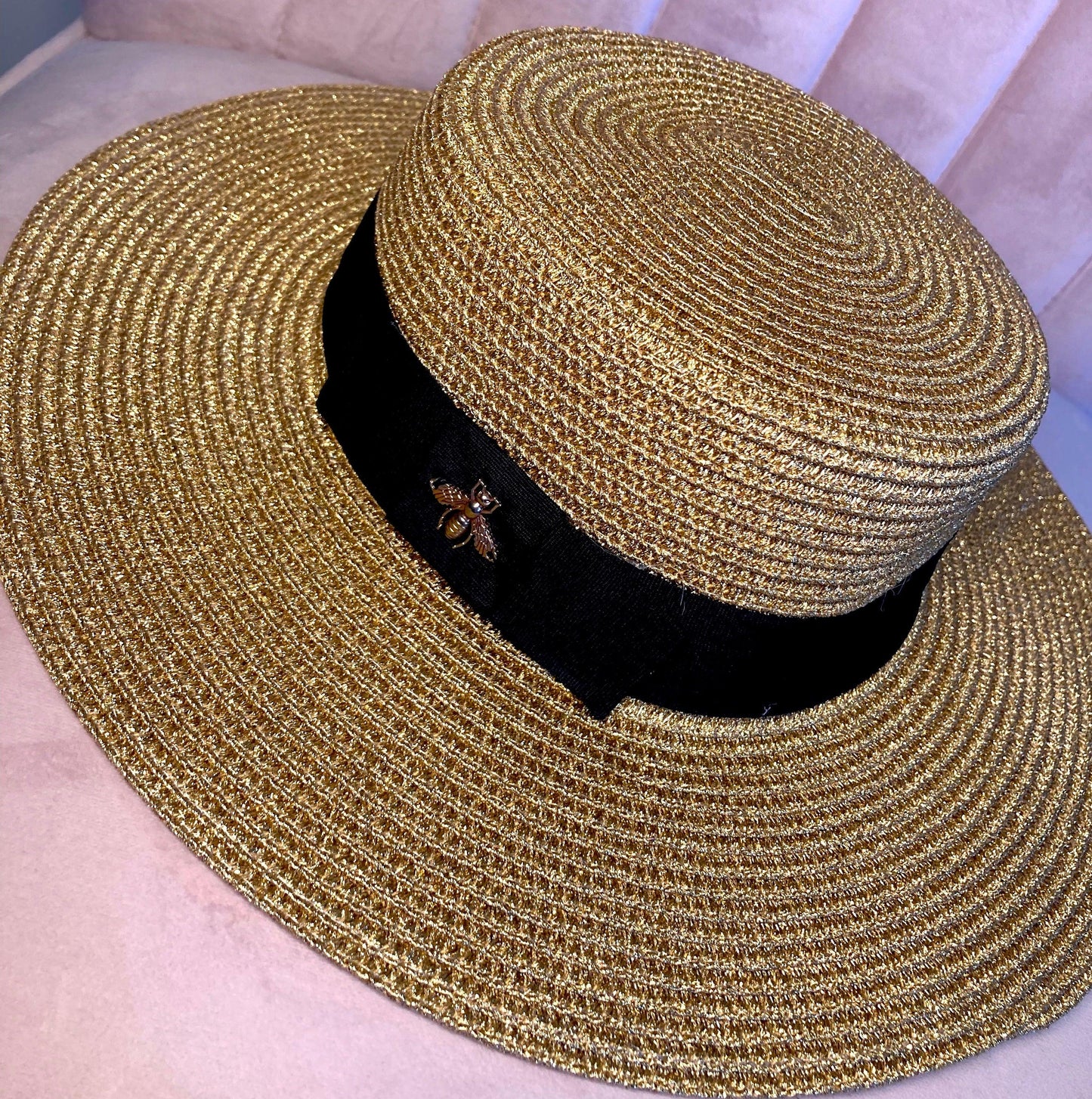 Straw Summer Hat with a gold, shiny Bee and Black Ribbon from Above