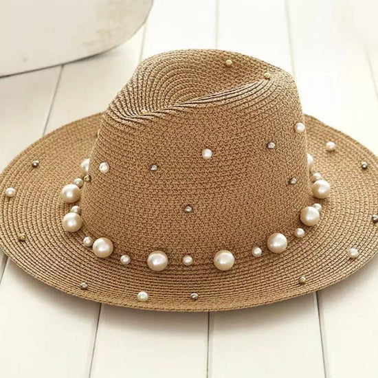 Summer sun straw hat embellished with pearls of various sizes.